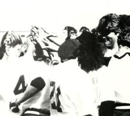 Black and white photo of softball players in a huddle