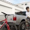 Young man grabs a bike to lift into a pickup truck