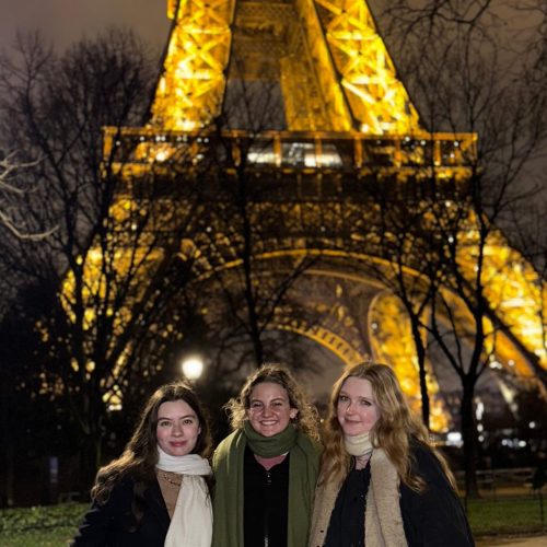 Students standing below the Eiffel Tower