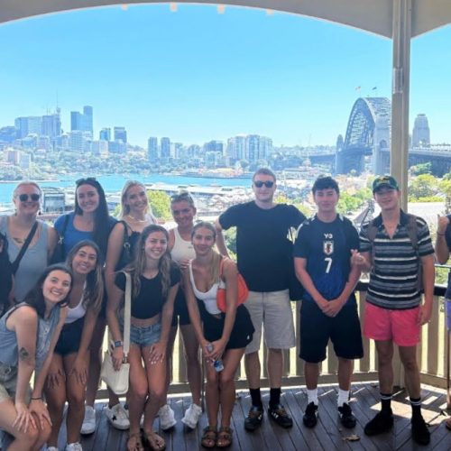 Group of students outside in front of city scape