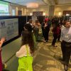 View of poster sessions and students in conversation with visitors