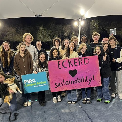 Large group of students stand with the president and a sign that reads "Eckerd hearts sustainability"